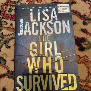 Lisa Jackson "The Girl Who Survived" Paperback Book - Blue & Gold Cover